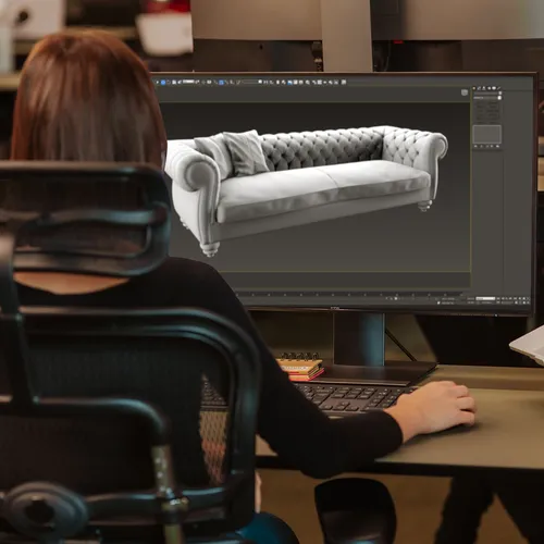 A 3D artist modelling a sofa in a 3D editor