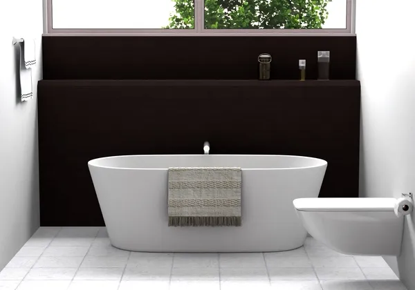A freestanding oval bathtub against a dark wood bathroom panel
