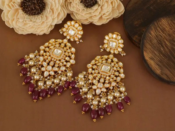 A pair of ornate gold and pearl chandelier earrings