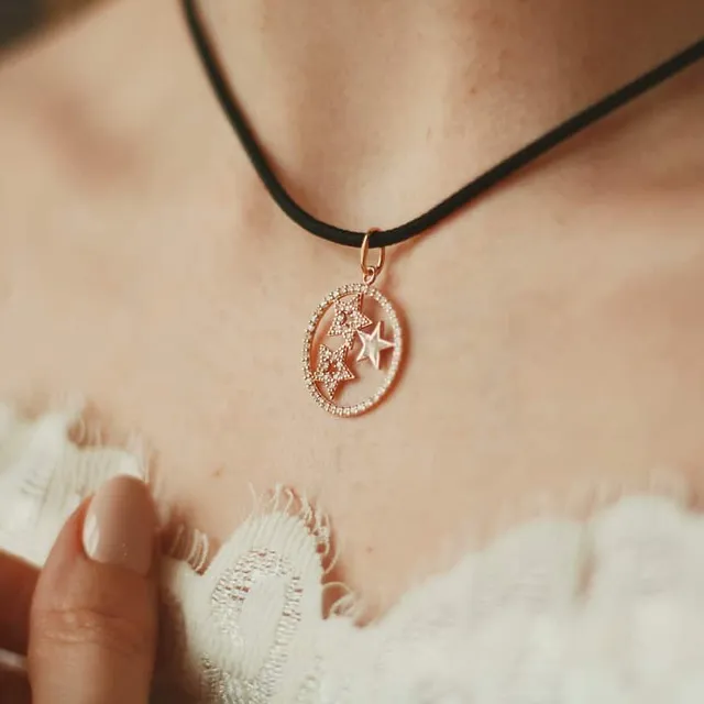 A pendant necklace worn close up, showing the emotional side of jewelry