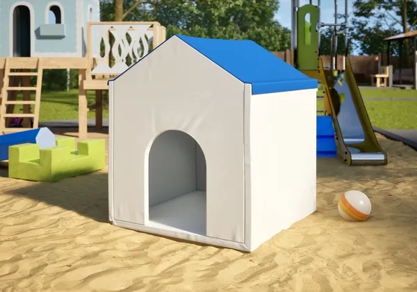 A soft padded play house on the sand of a playground