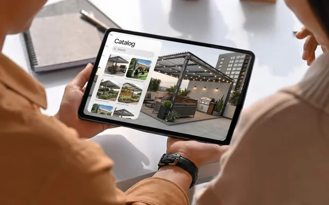 A sales associate placing an outdoor product in a yard from a branded iPad